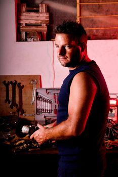 View of a garage mechanic man holding a power tool.