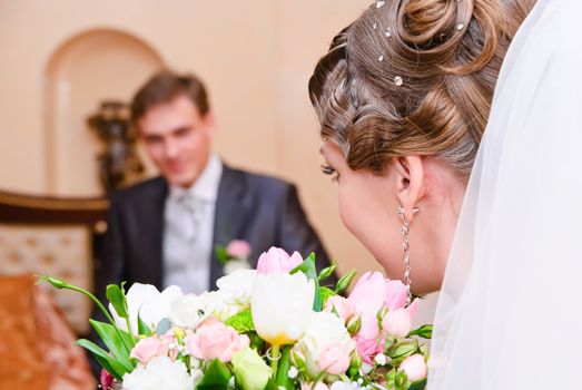 bridal bouquet of white roses and newlyweds