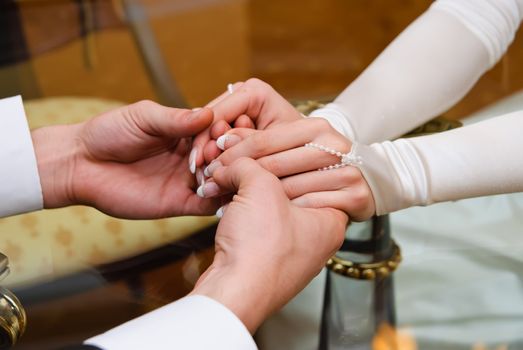 Hands of groom and bride