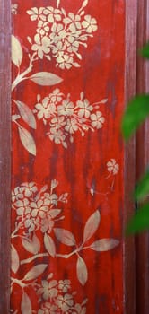 Wall painted with traditional Thai decorations.