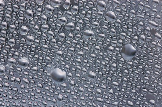 Abstract background. Condensate drops on a curved surface.