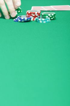 man's hand collects the chips with game table
