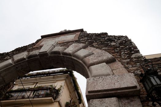 A old Greek arch that is the entrance to a theater in Messina, Italy