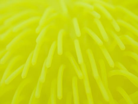 Macro of a yellow toy made of flexible polymer