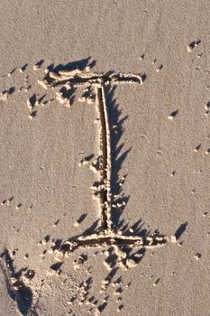 Letter I drawn in the sand. 