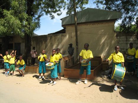 pupils playing music  at a roadside for a welcoming ceremony in north Cameroon