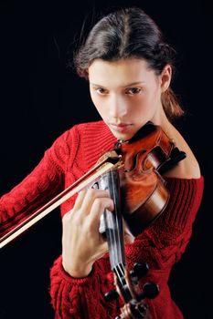 A young woman playing a violin with expression