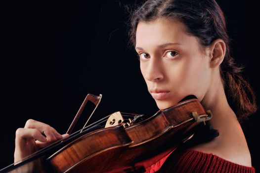 Musician playing violin. Isolated on the black background