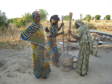 women cooking in a traditional way in north Cameroon