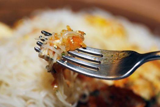 Noodles on a steel plug close up