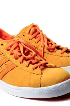 Orange sport shoe close up, isolated on white