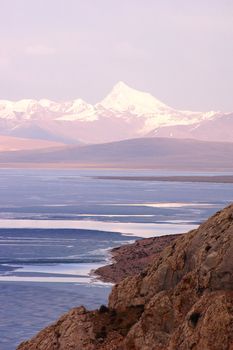 Landscape of blue lake and snow mountains at sunrise