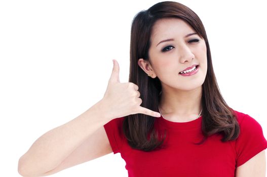 Portrait of a beautiful young woman winking and making a call gesture with her hand, isolated on white background.