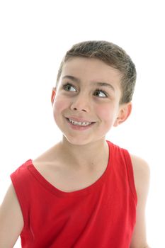 A beautiful smiling young boy is glancing sideways and smiling.  White background.