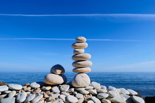 Balancing of white pebbles on the sea coast