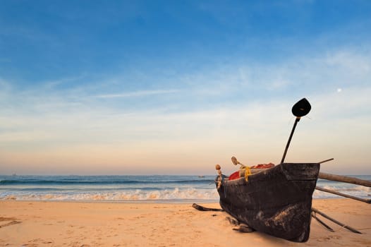 The old fishing boat on the sandy shore