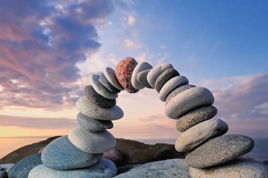 Arc crookedness of the pebbles on the seashore. On sunrise