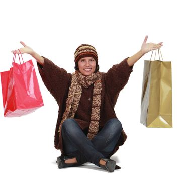 Happy woman with shopping bags isolated against a white background