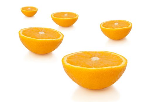 FIve freshly cut orange halves arranged over white.