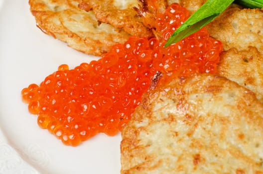 pancakes with red caviar and green onion closeup dish