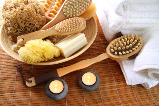 Assortment of spa brushes, sponges and soap  on bamboo mat 