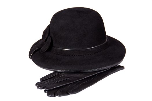 Images of a female hat lying on the leather gloves, isolated, on a white background