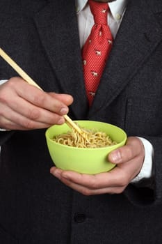 Man holding a bowl of soup noodles 