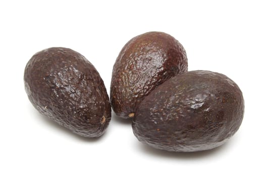 Three avocado fruits isolated on white background
