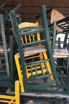 chairs from a restaurant, stacked outside
