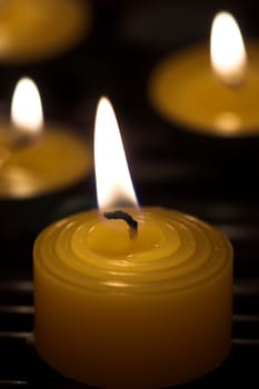  Some burning candles close up
