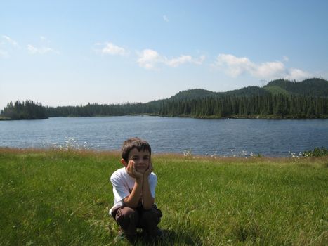 boy posing in front of a lake in Mauricie, Quebec