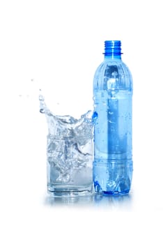 Glass of splashing water and plastic bottle isolated on white background with clipping path