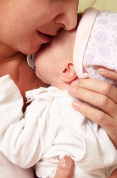 Mother with her sleeping newborn baby in home