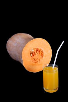 Images of a glass with the pumpkin juice, isolated, on a black background