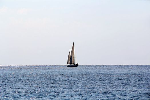 Landscape with calm sea and beautiful sailboat