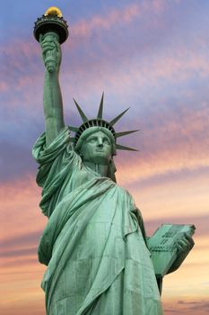 Photo of the Statue of Liberty in New York City under a vivid sky.