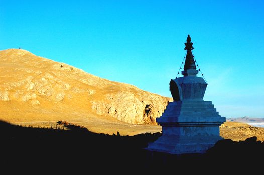 Landscape of white stupa in the highlands of Tibet at sunrise