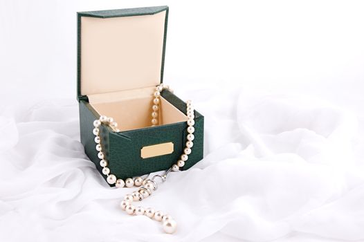 Pearl necklace in box on white