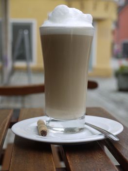 a cup of coffee over a wooden table