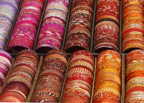 Detail of a stand with various colorful bracelets.