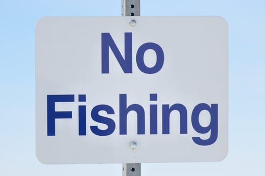 A no fishing sign on a post.