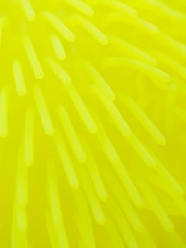 Macro of a yellow toy made of flexible polymer