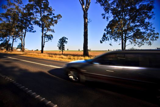 Driving very vast down a lonely road