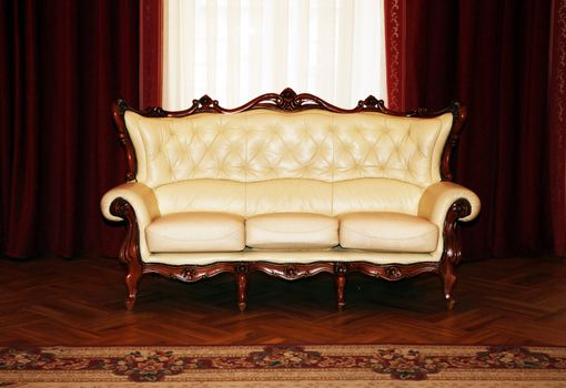 Beige sofa on a background of curtains