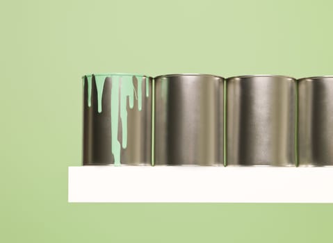 Paintcans in a row on green background