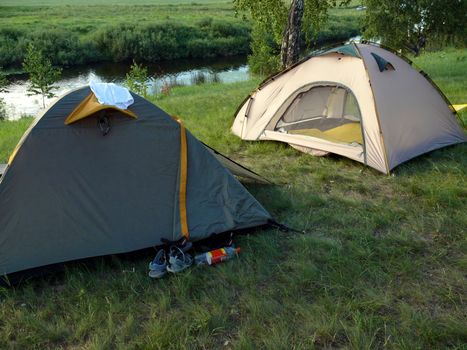 a couple of tent in river background