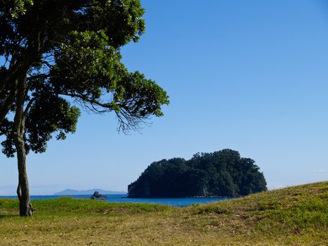 Rabbit Island, of coast of Mount Maunganui, New Zealand, with Mayor Island on horizon.