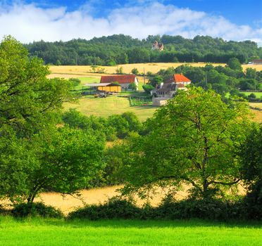 Scenic view on summer agricultural landscape in rural France with a farmhouse and barn