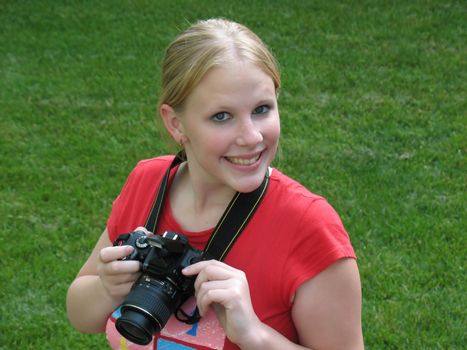 A beautiful young girl taking photographs, after taking a photography course.