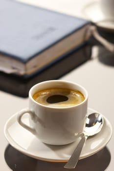 business still life: cup of coffee with writing-pad on the desk